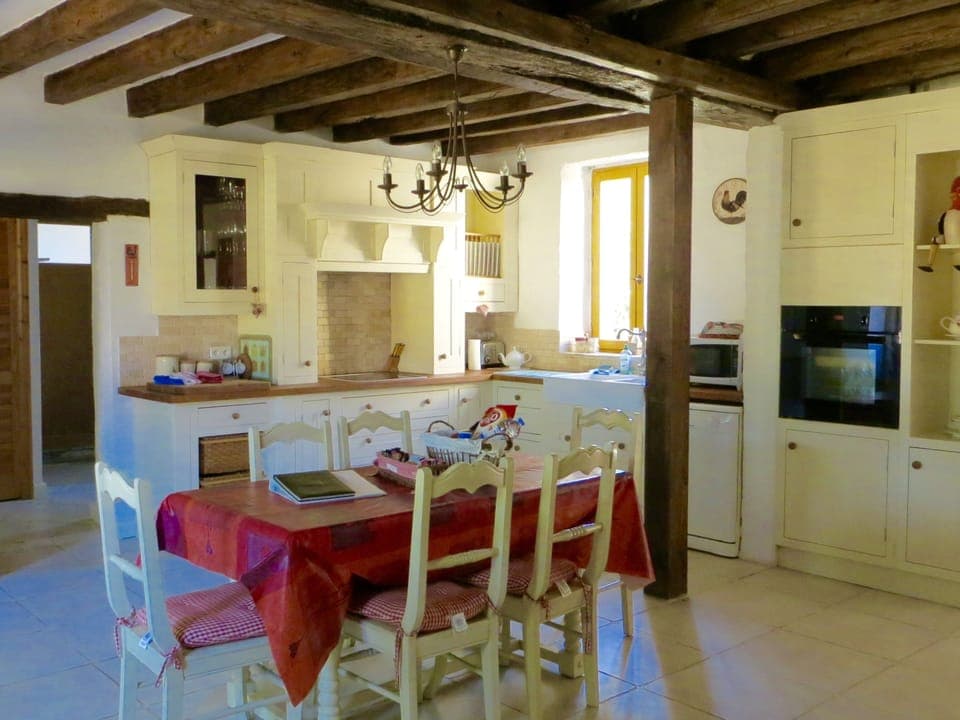 The fully equipped shaker style  kitchen complete with dining table and chairs.
