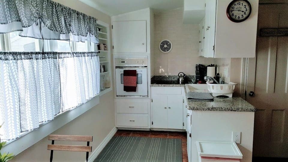 Fully stocked kitchen with cookware and small appliances.