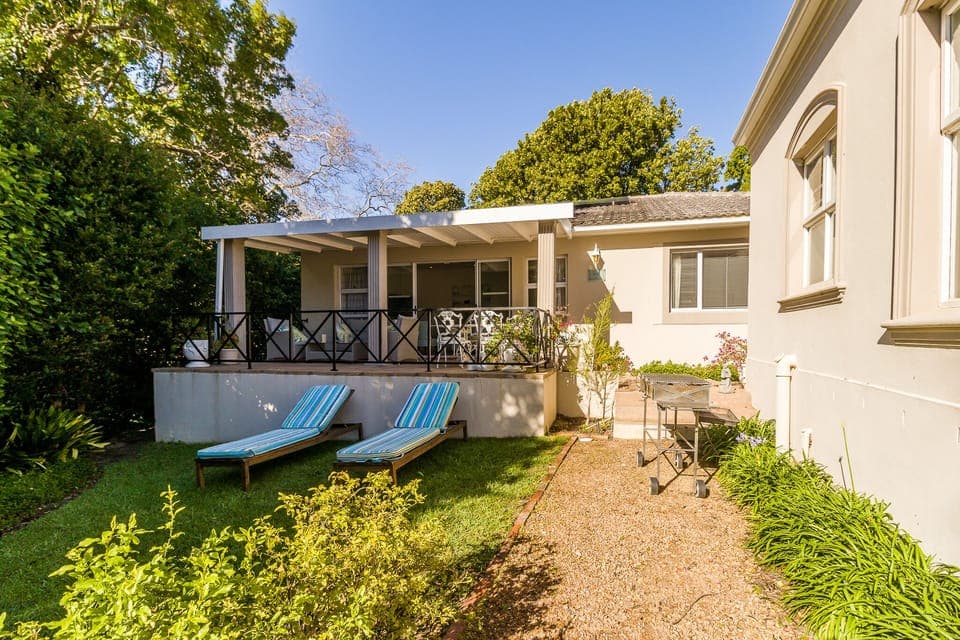 Sunny north facing secluded garden with sun loungers and braai