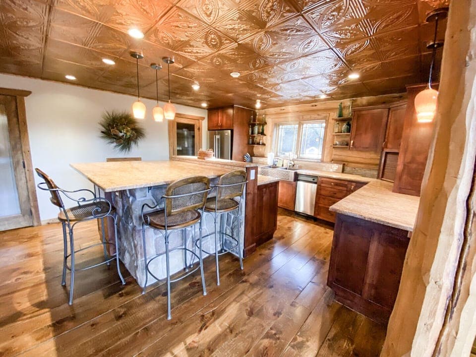 Find additional high-top seating for 3 at the kitchen bar.