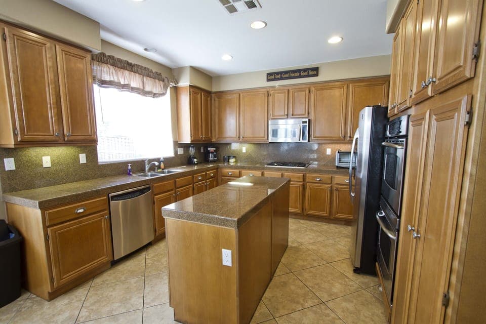 Large, fully stocked kitchen with island,  stainless appliances &  coffee maker