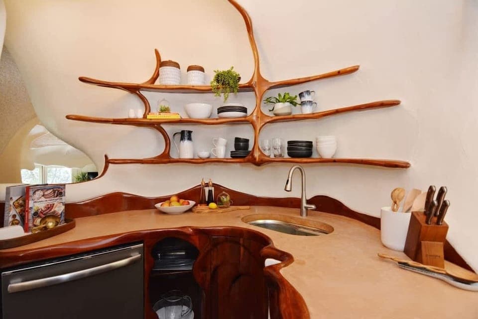 A thoughtfully designed kitchen featuring custom woodwork and organic lines that echo the home’s architecture.
