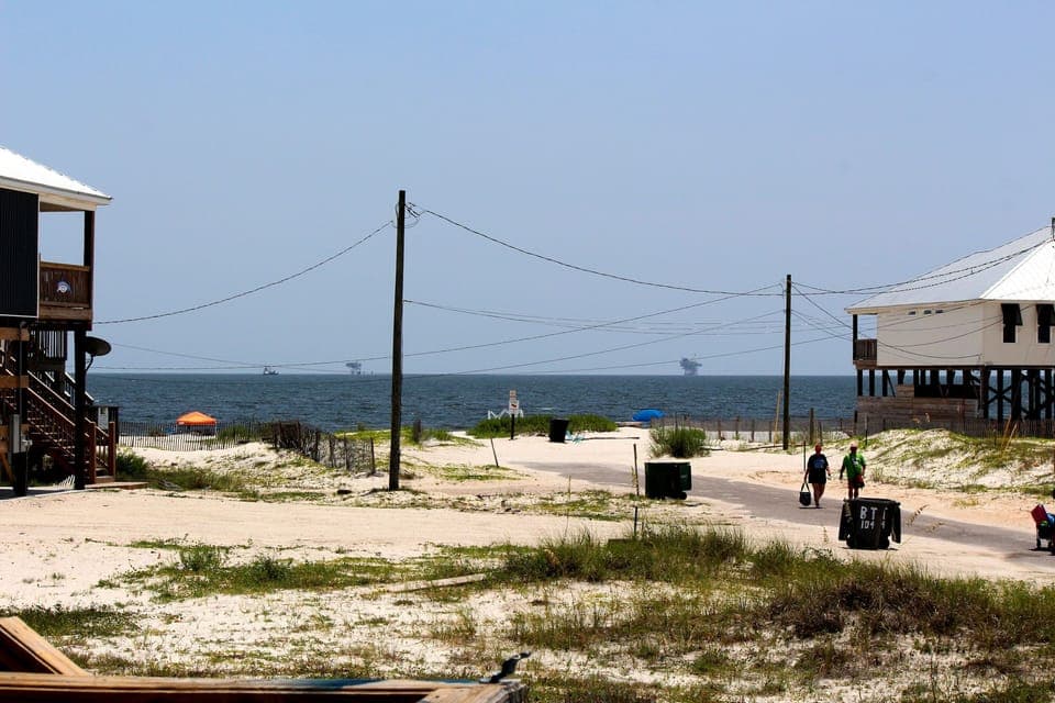 Beachfront community with elevated coastal homes offering direct access to pristine sandy shores and Gulf waters.
