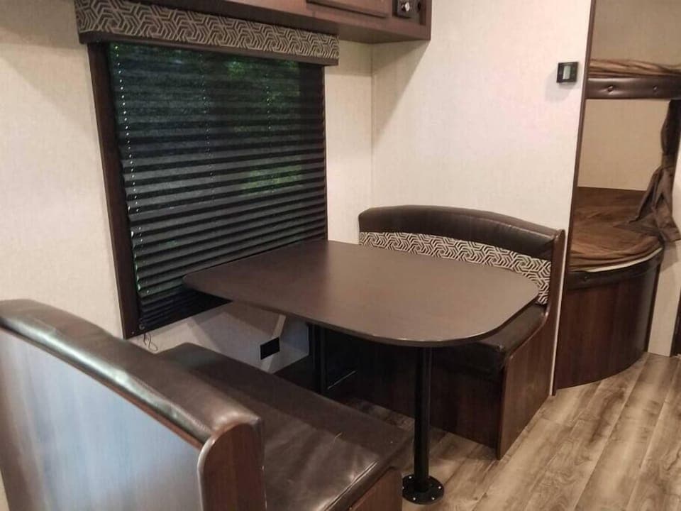 Dinette eating area with bunk beds in back. Dinette converts to sleeping area Camper B