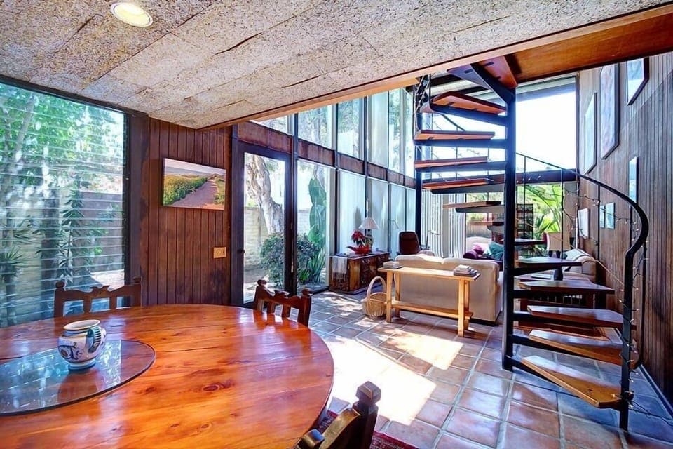 Dining/Living room area with plenty of natural light and vaulted ceiling
