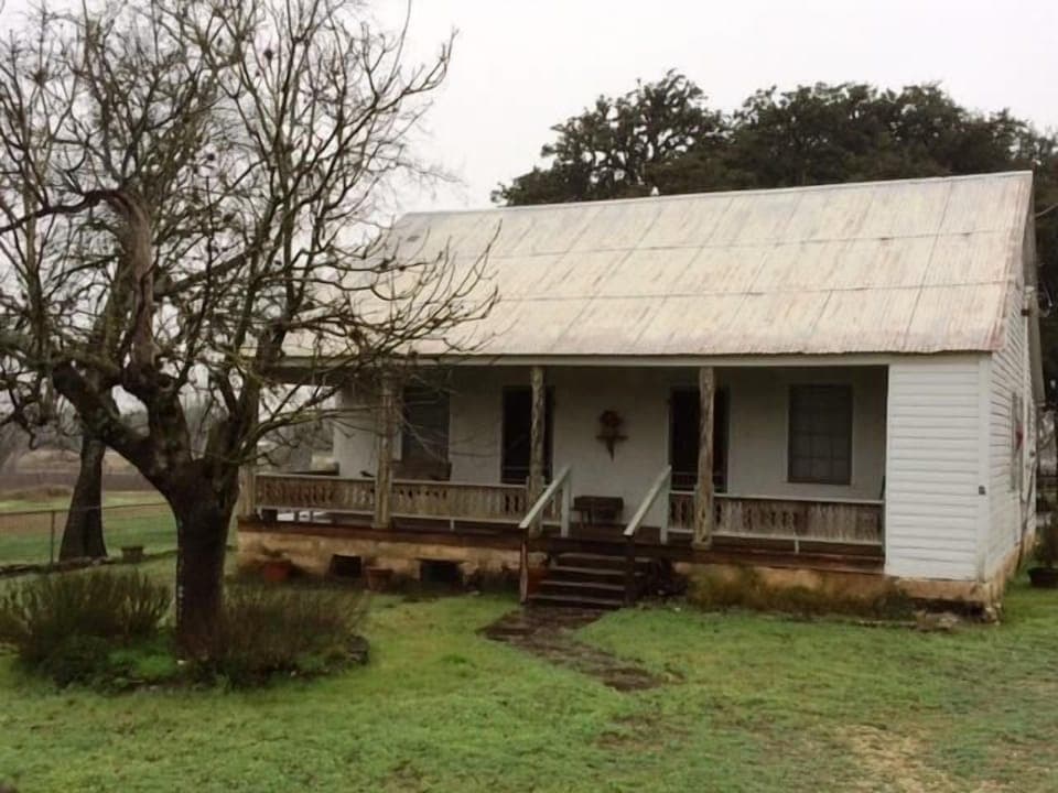 The outside of the farm house located on 70 acres!