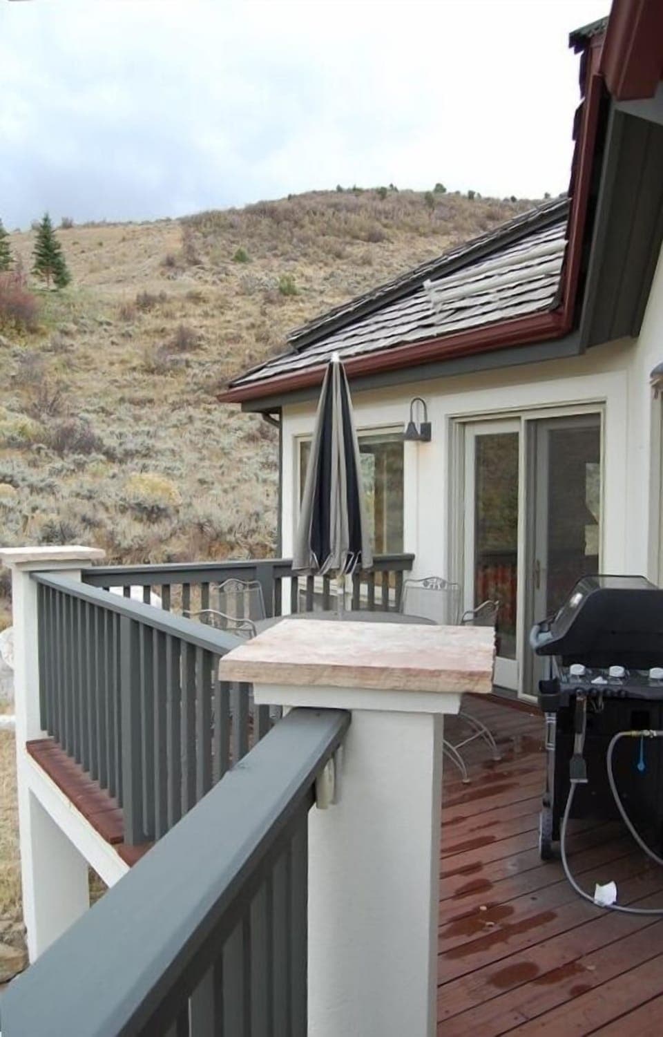East-facing sunrise deck with gas grill and patio table