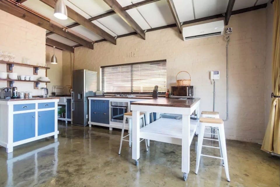 Fully equipped self catering kitchen and moveable bar/dining unit. 