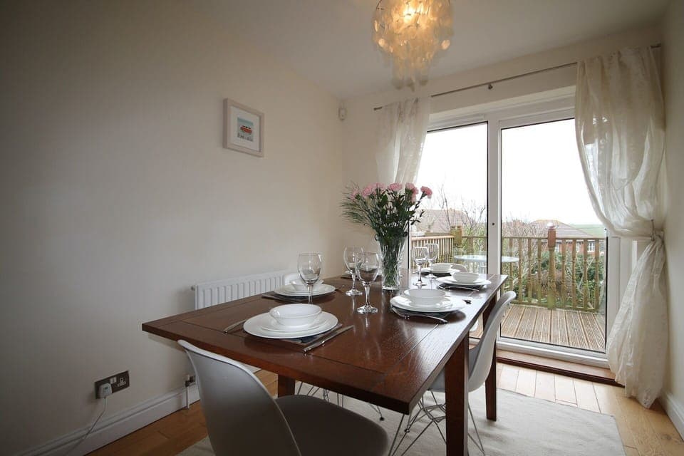 lounge and diner with patio doors leading onto the decking.