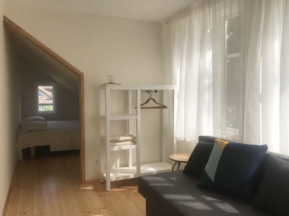 1# room with double bed & sofa with a private bathroom. The room is light.