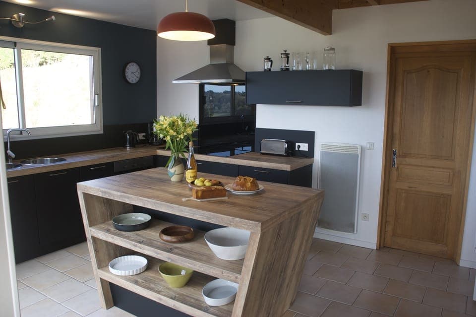 Fully equipped kitchen with two large fridges and freezer.