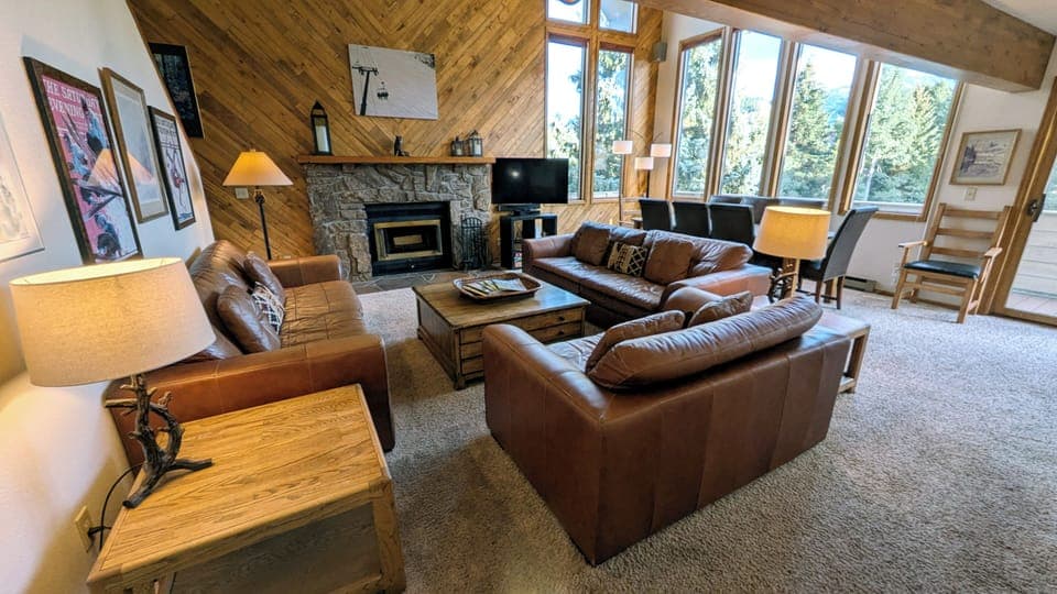 Living room with wood fireplace and dining table
