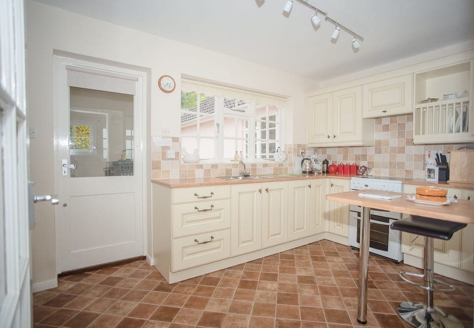 Fully equipped kitchen with garden and sea views.