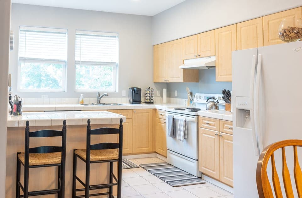 The kitchen is full stocked with appliances and basic supplies.