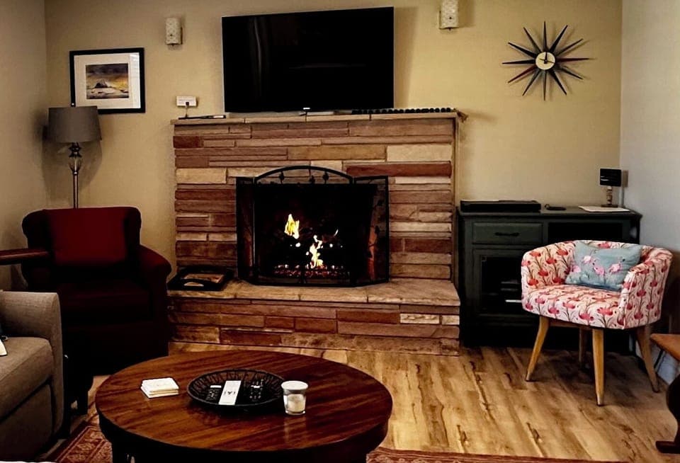 Family Room with cozy gas-buring fireplace and large smart TV.