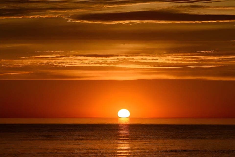 Unobstructed sunsets views over Lake Michigan from 2 balconies w/glass railings