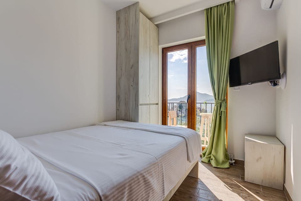 Small room with flat screen TV and balcony