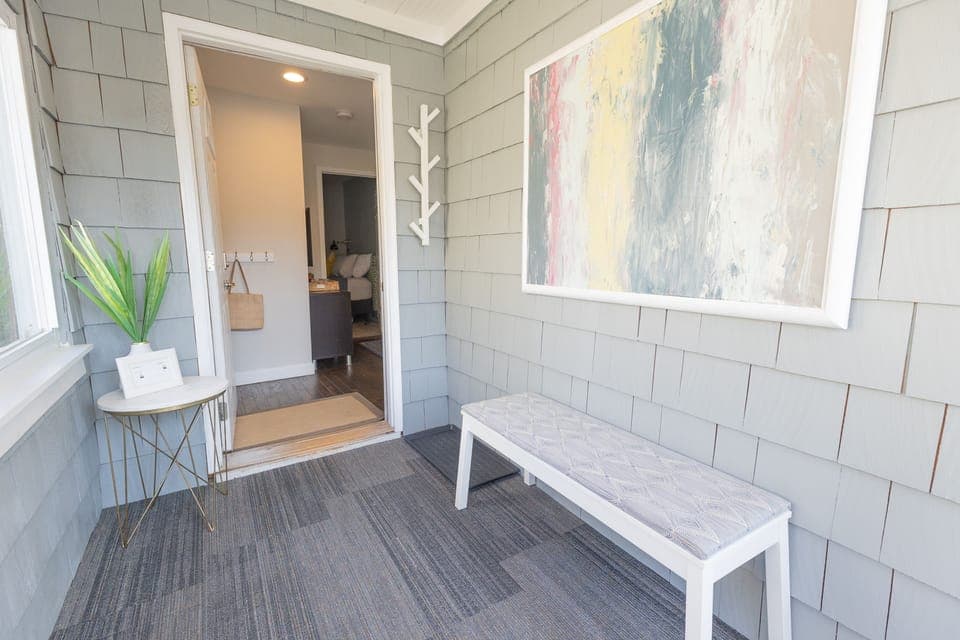 Inviting sun porch with motion sensor light; helpful for those night arrivals.