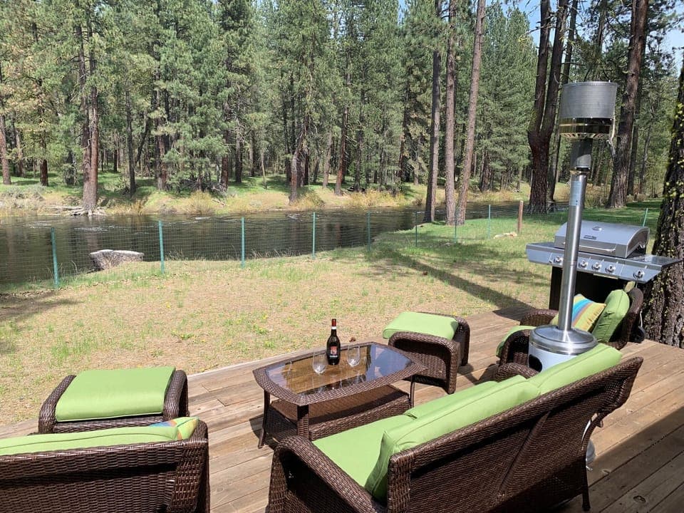 Relax on the back deck with a view of the river and forest.