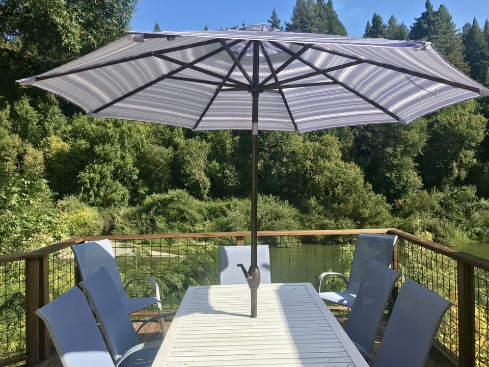 Deck overlooking the river with propane BBQ and seating for 8