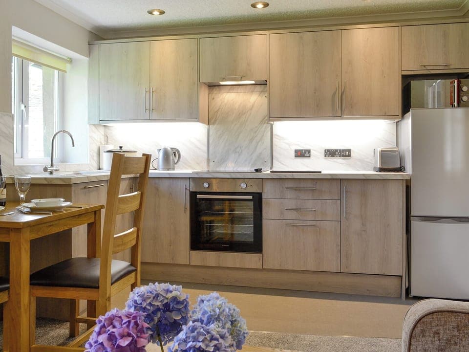 Modern fitted kitchen within the open-plan design | Jose&rsquo;s at the Grange - Grange Country House Holiday Cottages, Loweswater, near Cockermouth