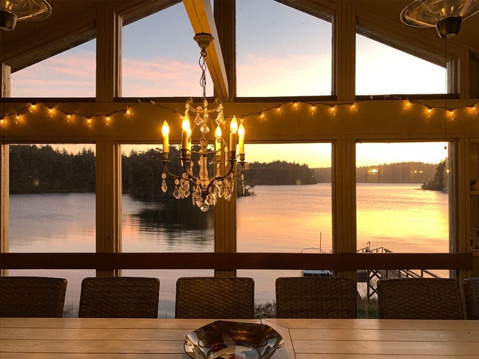 Enjoy the sunset on the covered deck under a chandelier.