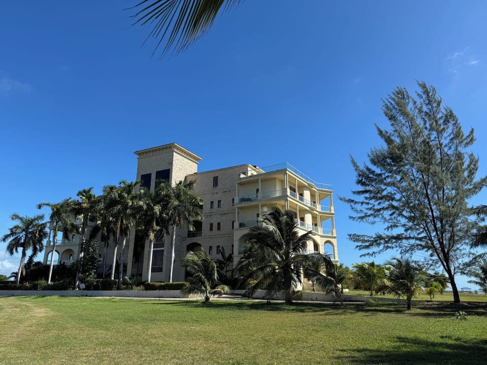 Magnificent architecture surrounded by palm trees and gardens. 