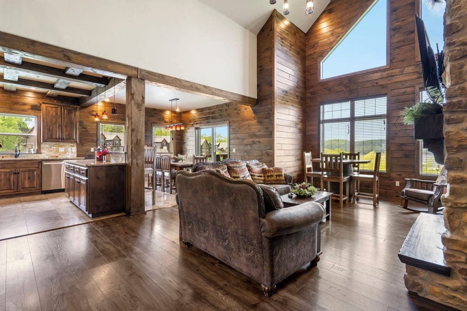 Comfortable living room with huge flat screen tv opens up to kitchen area