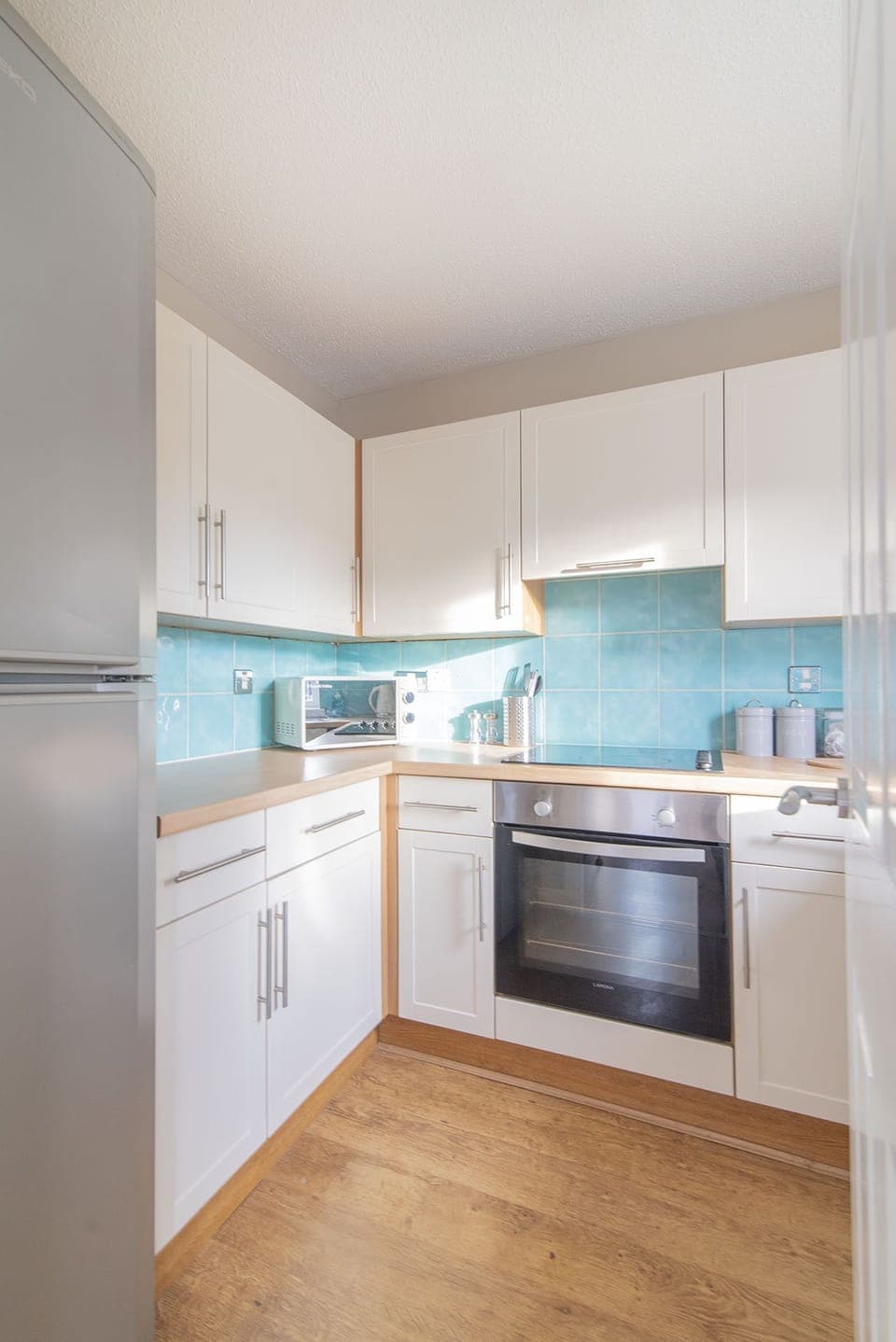 Modern fully fitted kitchen with washing machine 