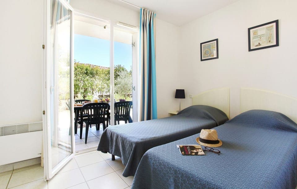 The second bedroom contains 2 Single beds.