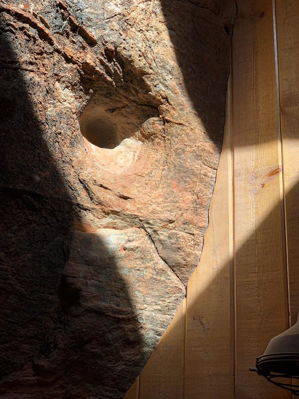 The skylight highlights the beautiful rock wall