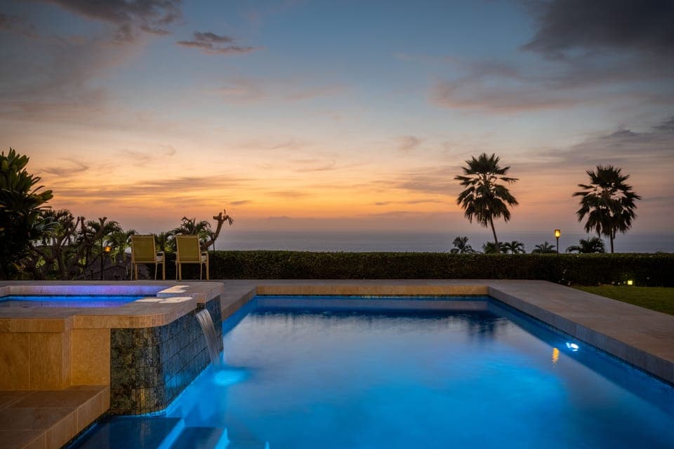 Night view of pool and spa