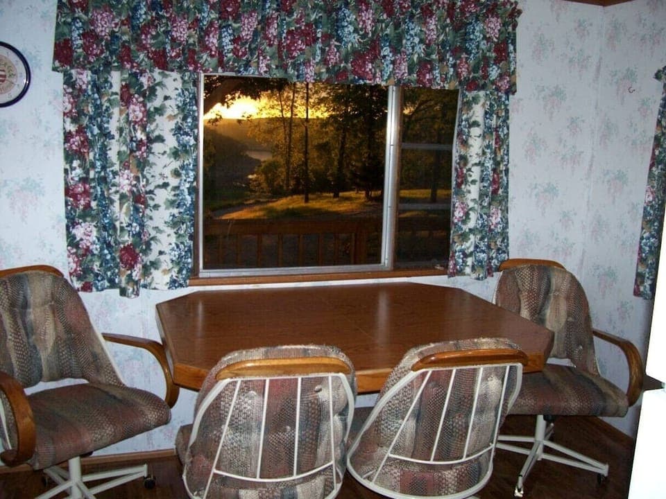 Dining room table boosts a view of the lake.