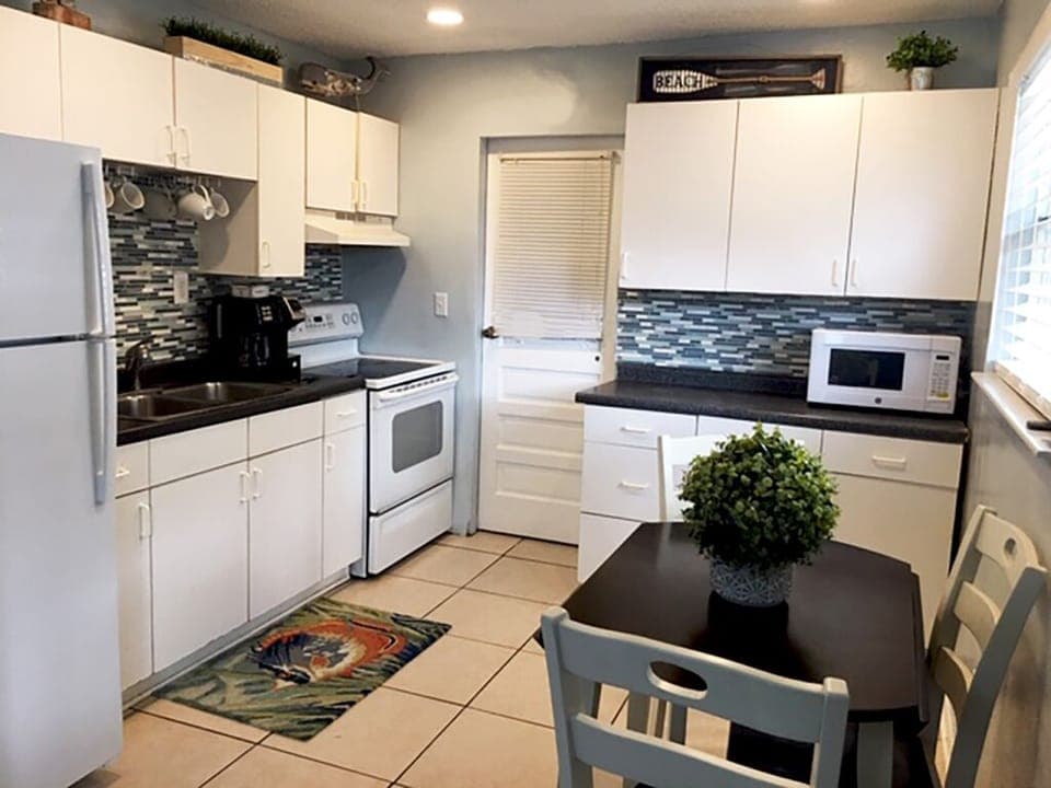 Kitchen and door leading to laundry room and side patio