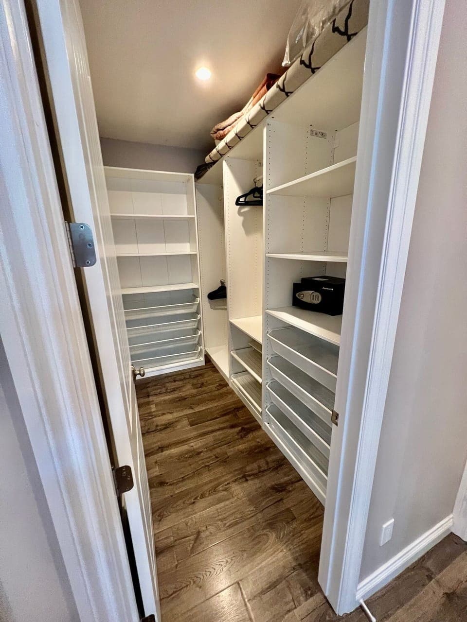 Main primary walk-in closet with safe