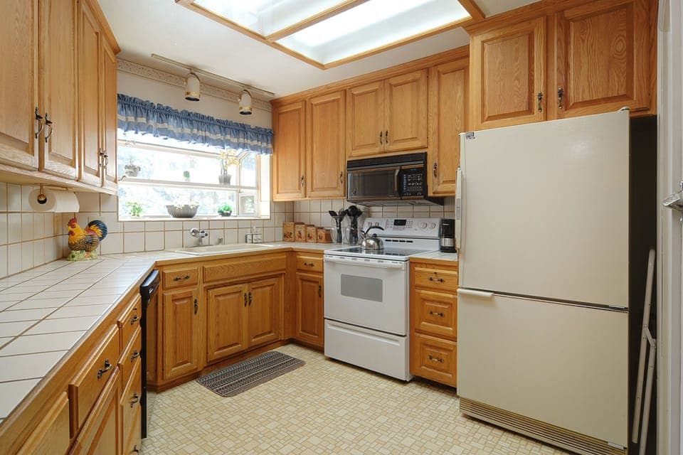 Fully stocked kitchen with electric stove and oven, microwave, dishwasher.