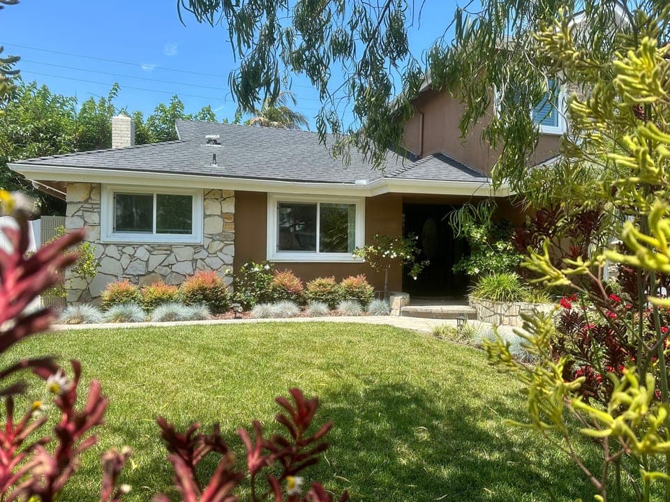 A comfortable home-away-from home with mature landscaping to relax by.