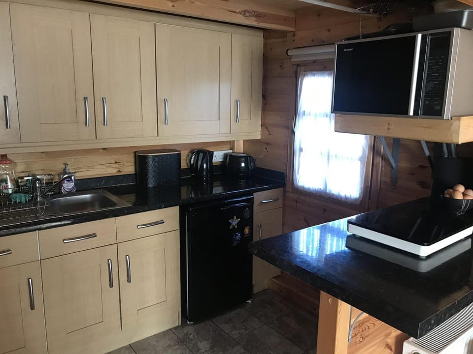 Kitchen with sink. fridge. kettle. toaster. micro combi oven. hob plate. 