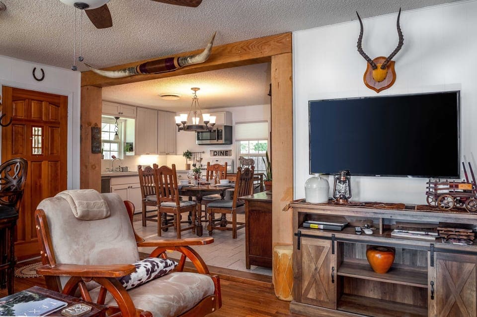 Living room with view into kitchen dining.
