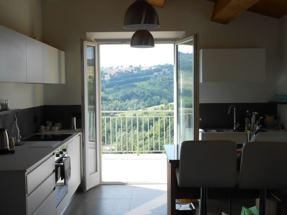 The kitchen is fresh, bright and modern and leads out onto the terrace.