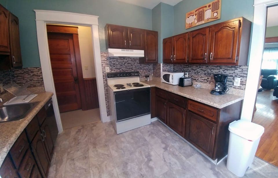 Fully stocked kitchen with range/stove, dishwasher, microwave, toaster, and more