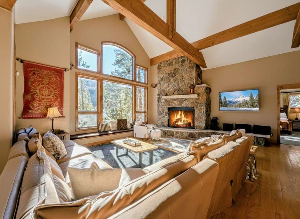 Cozy living space with large sectional, fireplace, tv, and views!