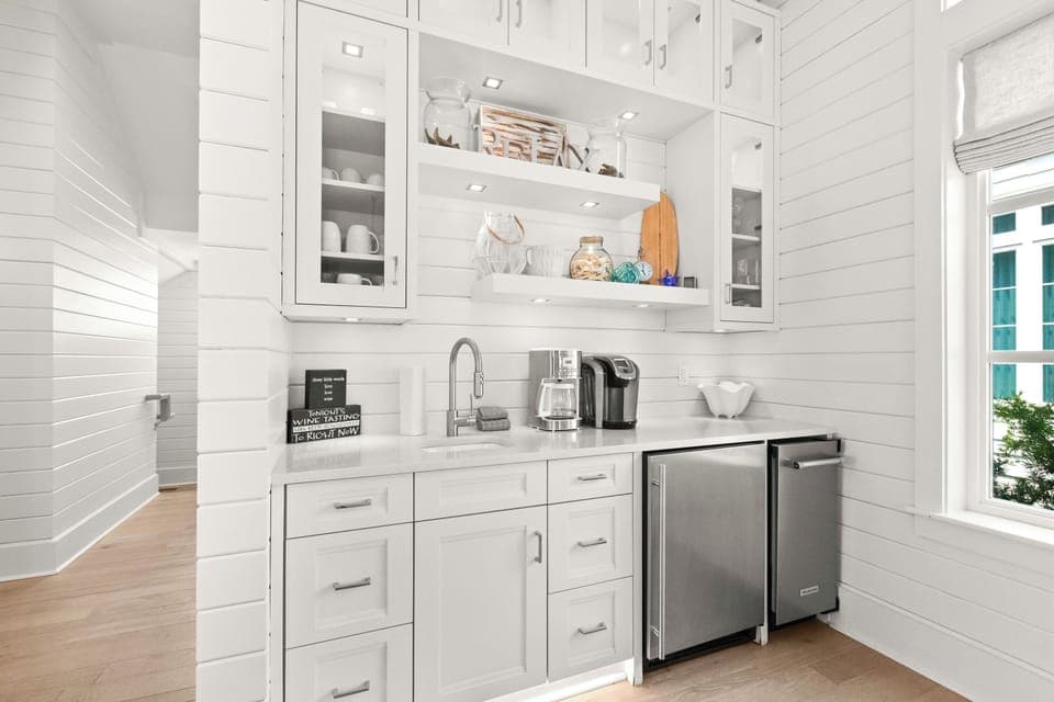 The bar includes an ice maker, mini-fridge, and coffee station