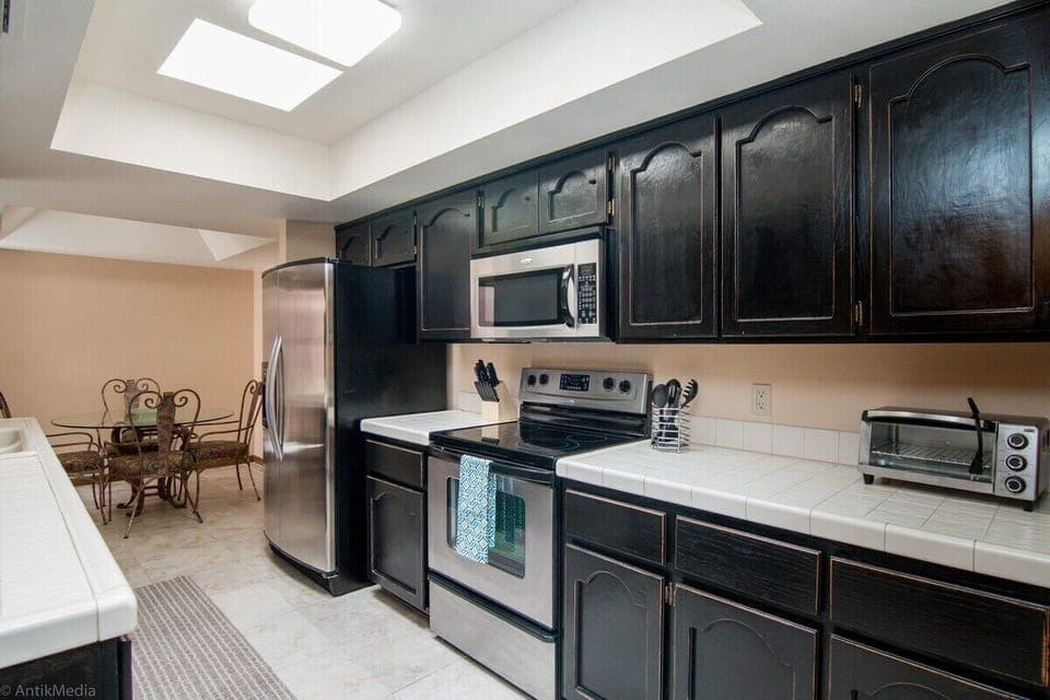Cabinets are now white and the Refrigerator is a Stainless Steel Samsung Model 