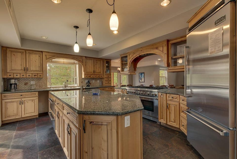 - Gourmet kitchen with large island counter  
- Stainless steel Viking appliances included  
- Mountain cabin rental with chef kitchen