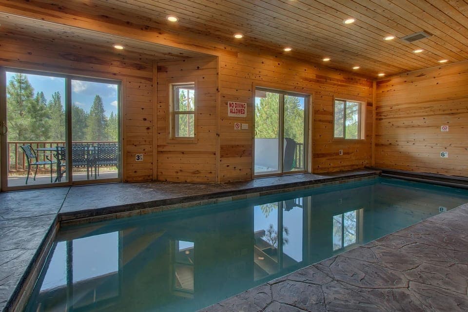 - Indoor pool retreat with wood cabin charm  
- Relaxing mountain views from sliding glass doors  
- Year-round private pool perfect for family fun