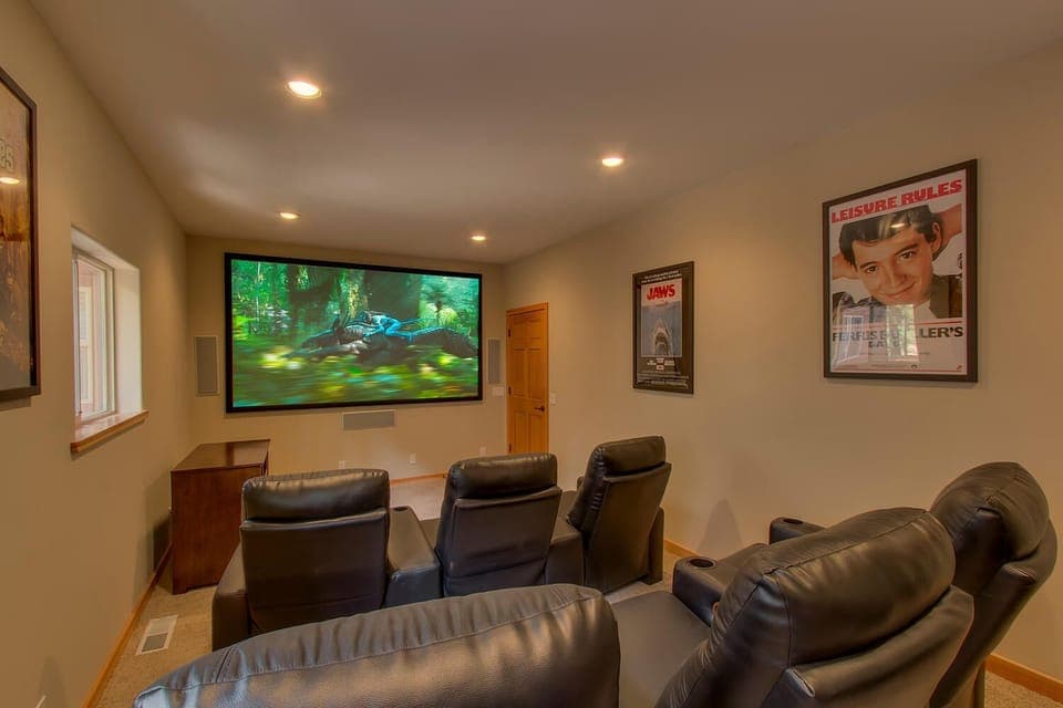 - Private theater room with recliner seating  
- Huge screen for movie nights and streaming  
- Family entertainment in cozy mountain style