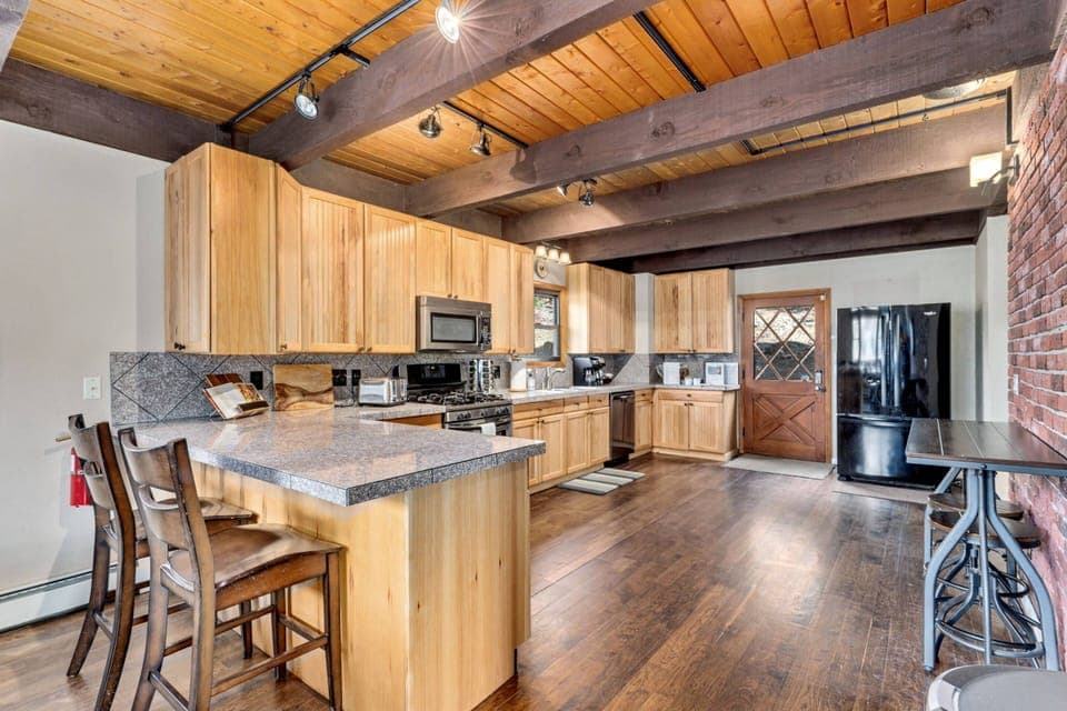 The kitchen has new and updated features, including dishwasher, refrigerator, plates and cutlery.