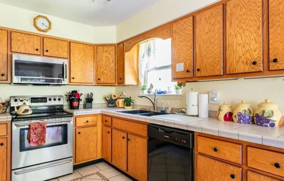Right side of Kitchen has double granite sink, & additional cabinets dinnerware