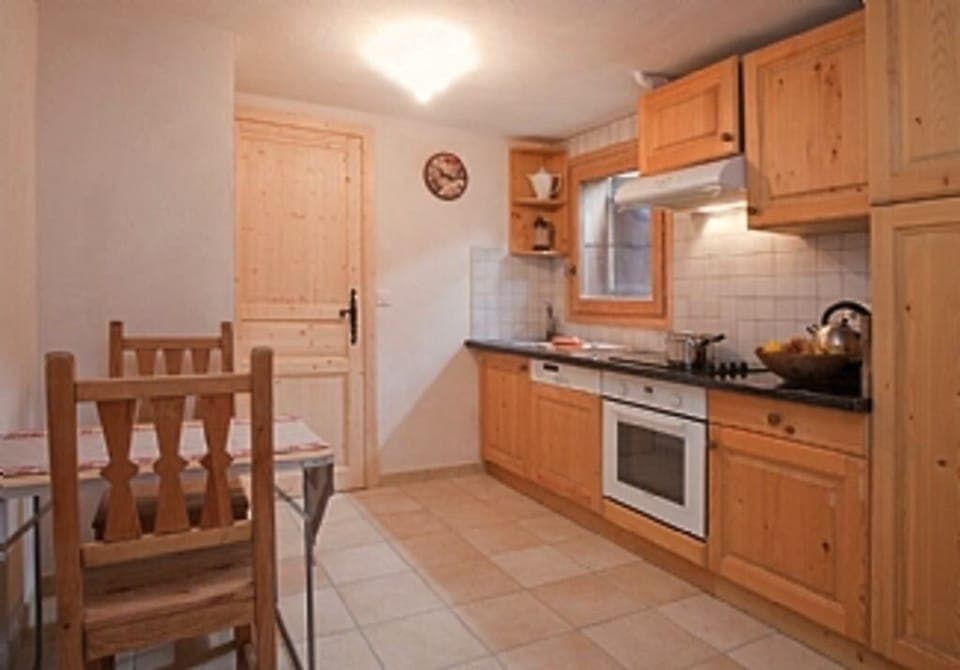 French Mountain Chalet. Kitchen, breakfast table. Door through to boot room. 